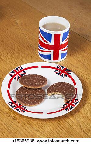 Stock Photo - Chocolate biscuits in plate with British coffee mug. Fotosearch