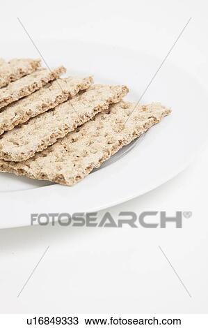 Stock Image - Close-up of crackers in plate. Fotosearch