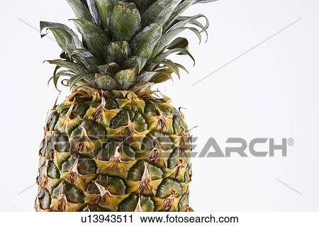 Stock Image - Close-up of fresh pineapple over white background. Fotosearch