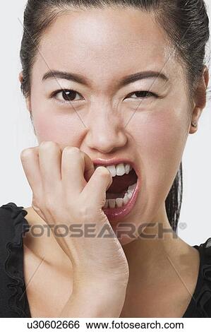 Close-up of frustrated Chinese woman over white background View Large Photo Image Stock Photograph - Close-up of frustrated Chinese woman over white background. Fotosearch
