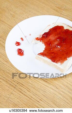 Close-up of jam spread on slice of bitten bread View Large Photo Image Picture - Close-up of jam spread on slice of bitten bread. Fotosearch