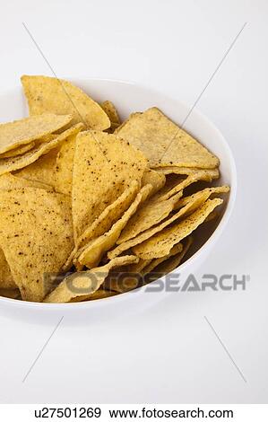 Close-up of nachos in bowl over white background View Large Photo Image Stock Photo - Close-up of nachos in bowl over white background. Fotosearch