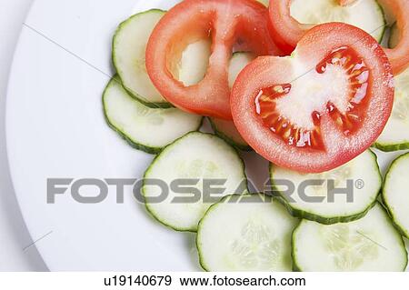 Close-up of sliced tomatoes and cucumbers in plate View Large Photo Image Stock Photo - Close-up of sliced tomatoes and cucumbers in plate. Fotosearch