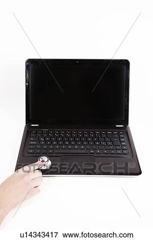 Close-up of stethoscope diagnosing laptop over white background View Large Photo Image Stock Photo - Close-up of stethoscope diagnosing laptop over white background. Fotosearch