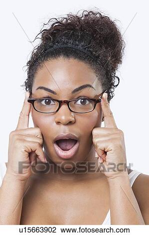Close-up portrait of surprised African American young woman with mouth open over white background View Large Photo Image Stock Image - Close-up portrait of surprised African American young woman with mouth open over white background. Fotosearch