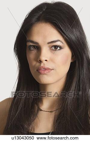 Close-up portrait of young woman over white background View Large Photo Image Stock Image - Close-up portrait of young woman over white background. Fotosearch