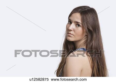 Close-up portrait of young woman over white background View Large Photo Image Stock Photography - Close-up portrait of young woman over white background. Fotosearch