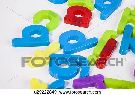 Close-up view of alphabet magnets scattered over white background View Large Photo Image Stock Photo - Close-up view of alphabet magnets scattered over white background. Fotosearch