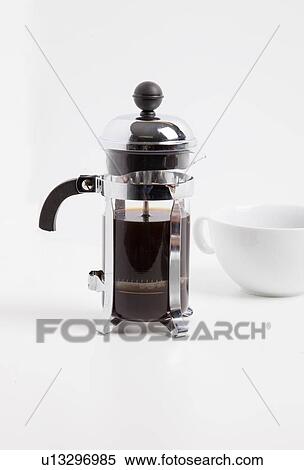 Stock Photography - Coffee maker and cup against white background. Fotosearch