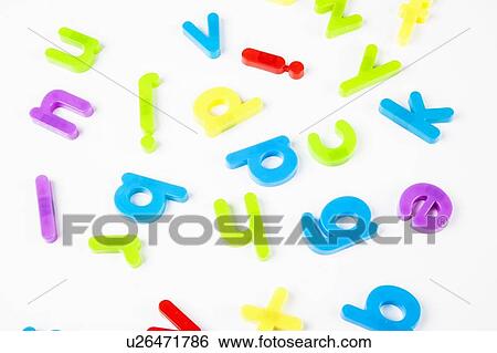 Stock Photograph - Colorful alphabet magnets scattered over white background. Fotosearch