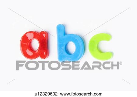 Stock Image - Colorful alphabet magnets spell 'a b c' over white background. Fotosearch