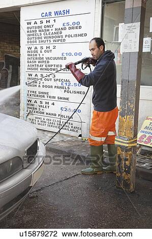 Employee washing vehicle at car wash View Large Photo Image Stock Image - Employee washing vehicle at car wash. Fotosearch