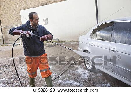 Employee washing vehicle at car wash View Large Photo Image Stock Image - Employee washing vehicle at car wash. Fotosearch