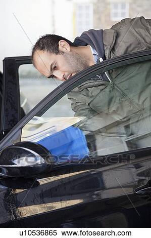 Employee wiping vehicle window in car wash View Large Photo Image Stock Photography - Employee wiping vehicle window in car wash. Fotosearch