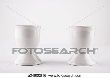 Stock Photograph - Empty egg cups side by side over white background. Fotosearch