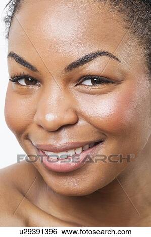 Extreme close-up of smiling young African American woman over white background View Large Photo Image Stock Photograph - Extreme close-up of smiling young African American woman over white background. Fotosearch