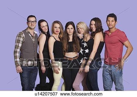 Group portrait of casual multi ethnic friends posing over purple background View Large Photo Image Stock Photo - Group portrait of casual multi ethnic friends posing over purple background. Fotosearch