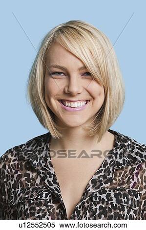 Portrait of beautiful young woman smiling over blue background View Large Photo Image Stock Photography - Portrait of beautiful young woman smiling over blue background. Fotosearch