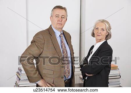 Portrait of confident businessman and woman in office View Large Photo Image Picture - Portrait of confident businessman and woman in office. Fotosearch