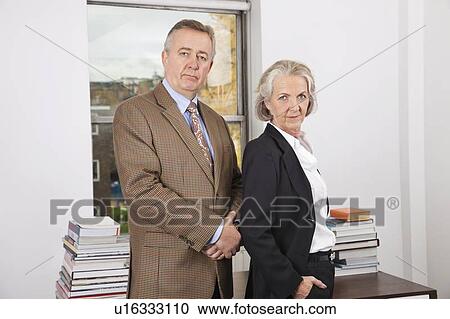 Portrait of confident businessman and woman in office View Large Photo Image Stock Image - Portrait of confident businessman and woman in office. Fotosearch