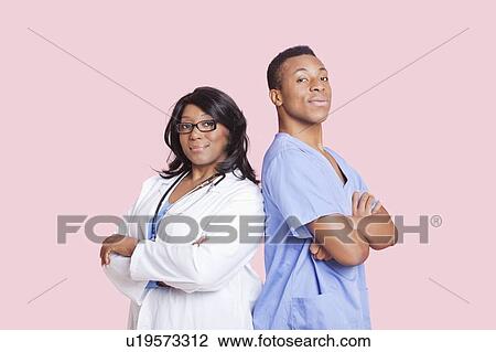 Portrait of confident mixed race male and female surgeons over pink background View Large Photo Image Stock Image - Portrait of confident mixed race male and female surgeons over pink background. Fotosearch
