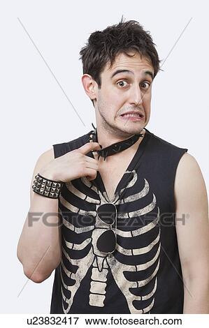 Stock Photo - Portrait of displeased young punk man over white background. Fotosearch