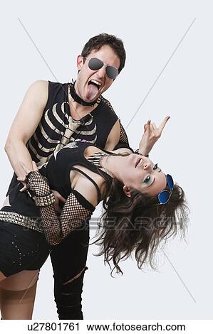 Portrait of gothic young couple dancing over white background View Large Photo Image Stock Image - Portrait of gothic young couple dancing over white background. Fotosearch