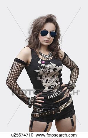 Portrait of gothic young woman with hands on hips over white background View Large Photo Image Stock Image - Portrait of gothic young woman with hands on hips over white background. Fotosearch