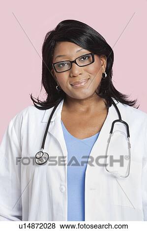 Portrait of mixed race female surgeon smiling over pink background View Large Photo Image Stock Photo - Portrait of mixed race female surgeon smiling over pink background. Fotosearch