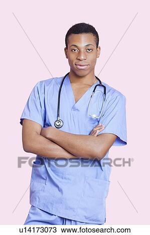 Portrait of mixed race male surgeon with arms crossed over pink background View Large Photo Image Stock Image - Portrait of mixed race male surgeon with arms crossed over pink background. Fotosearch