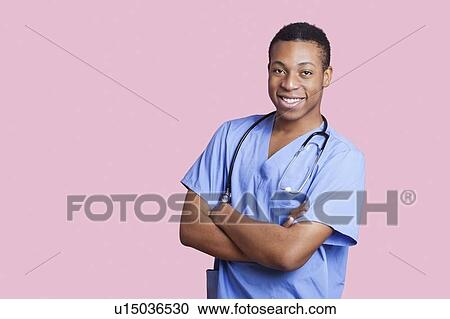 Portrait of mixed race male surgeon with arms crossed over pink background View Large Photo Image Stock Image - Portrait of mixed race male surgeon with arms crossed over pink background. Fotosearch