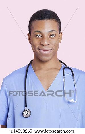 Portrait of mixed race male surgeon over pink background View Large Photo Image Stock Photo - Portrait of mixed race male surgeon over pink background. Fotosearch