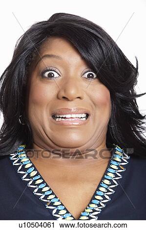 Portrait of mixed race woman grimacing over white background View Large Photo Image Stock Image - Portrait of mixed race woman grimacing over white background. Fotosearch