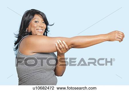 Portrait of mixed race woman stretching over blue background View Large Photo Image Stock Image - Portrait of mixed race woman stretching over blue background. Fotosearch