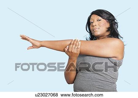 Portrait of mixed race woman stretching over blue background View Large Photo Image Stock Photo - Portrait of mixed race woman stretching over blue background. Fotosearch