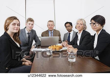 Portrait of multiethnic professionals in meeting at conference room View Large Photo Image Stock Image - Portrait of multiethnic professionals in meeting at conference room. Fotosearch