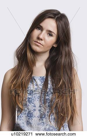 Portrait of serious young woman over white background View Large Photo Image Stock Image - Portrait of serious young woman over white background. Fotosearch