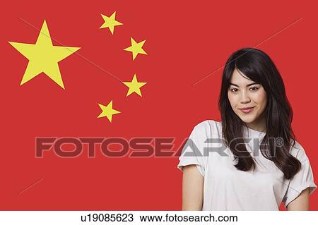 Portrait of smiling mixed race young woman against Chinese flag View Large Photo Image Stock Image - Portrait of smiling mixed race young woman against Chinese flag. Fotosearch