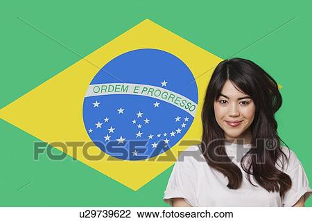 Portrait of smiling mixed race young woman against Brazilian flag View Large Photo Image Stock Image - Portrait of smiling mixed race young woman against Brazilian flag. Fotosearch
