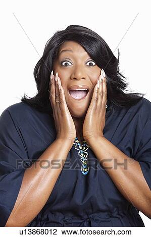 Stock Image - Portrait of surprised mixed race woman over white background. Fotosearch