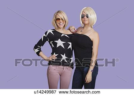 Portrait of two beautiful multi ethnic women smiling over purple background View Large Photo Image Stock Photo - Portrait of two beautiful multi ethnic women smiling over purple background. Fotosearch