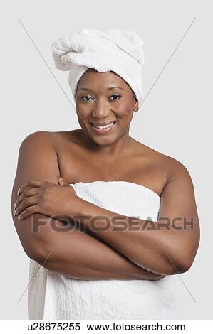 Stock Photography - Portrait of woman with body and head wrapped in towels over white background. Fotosearch