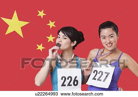 Portrait of young medalists standing against Chinese flag View Large Photo Image Stock Image - Portrait of young medalists standing against Chinese flag. Fotosearch
