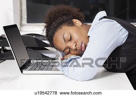 Side view of exhausted businesswoman with head on laptop in office View Large Photo Image Stock Photo - Side view of exhausted businesswoman with head on laptop in office. Fotosearch