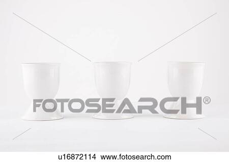 Three empty egg cups side by side over white background View Large Photo Image Picture - Three empty egg cups side by side over white background. Fotosearch