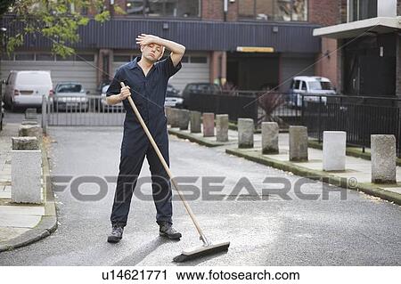 Tired young male street sweeper View Large Photo Image Stock Image - Tired young male street sweeper. Fotosearch