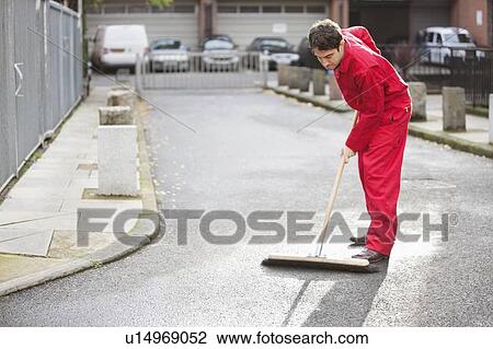 Stock Image - Young male street sweeper. Fotosearch