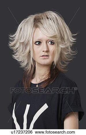Young woman with modern hairstyle over black background View Large Photo Image Stock Photograph - Young woman with modern hairstyle over black background. Fotosearch