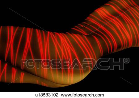 Abstract red laser-painted beautiful nude female body 