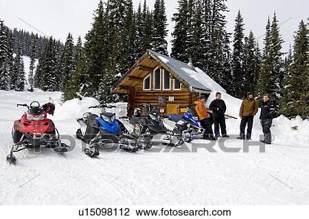 Snowmobilers Take Time Out At A Warming Cabin To Rest Up During A